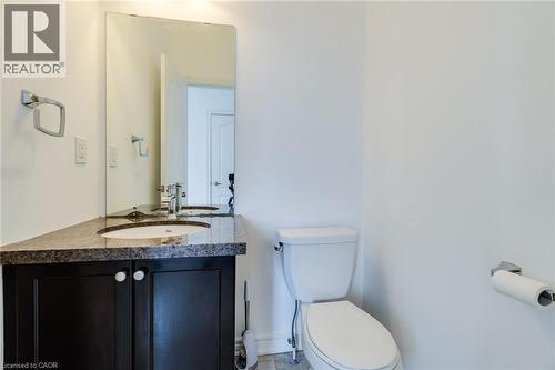 Vanity with dark wood-finish cabinetry, integrated sink, and stone countertop - 2 Hawstone Road, Vellore, ON 