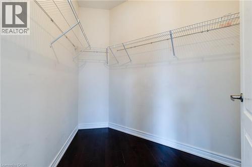 Walk-in closet with dark wood-finish flooring and wire shelving - 2 Hawstone Road, Vellore, ON 