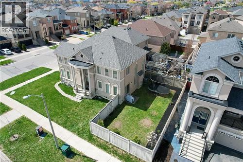 Two-story residential architecture with a prominent portico entrance, multiple windows, and a gray shingle roof - 2 Hawstone Road, Vellore, ON 