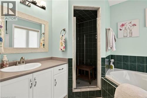 Vanity with an oval sink, brushed nickel faucet, and white cabinetry - 31 Grindstone Way, Hamilton, ON 