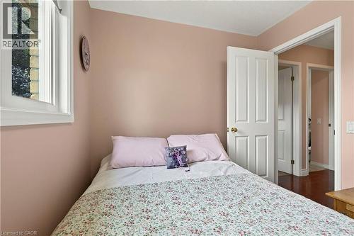 White trim window, light-toned walls, and wood-finish flooring - 31 Grindstone Way, Hamilton, ON 