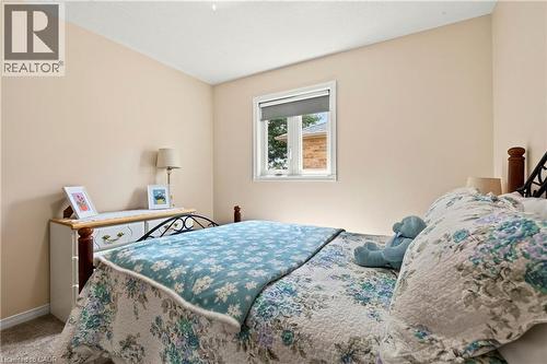 Neutral wall paint, window with roller shade, textured ceiling, and carpet flooring - 31 Grindstone Way, Hamilton, ON 