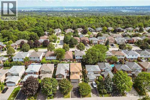 Residential neighborhood with a variety of housing styles, established landscaping, and distant urban skyline - 31 Grindstone Way, Hamilton, ON 