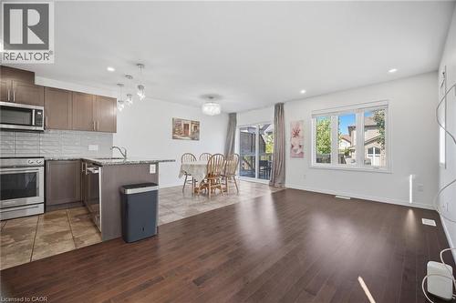 Wood-finish flooring throughout the main living area - 135 Hardcastle Drive Unit# 85, Cambridge, ON 