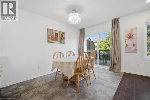 Tiled flooring, overhead light fixture, sliding glass door, white trim, and a window - 135 Hardcastle Drive Unit# 85, Cambridge, ON 