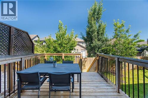 Expansive wood deck with black metal balusters and a lattice privacy screen - 135 Hardcastle Drive Unit# 85, Cambridge, ON 