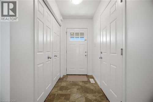 Tile flooring, white paneled doors, white walls, and a ceiling-mounted light fixture - 135 Hardcastle Drive Unit# 85, Cambridge, ON 