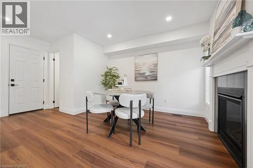 Wood-finish flooring throughout, recessed lighting, and a white paneled door with matte black hardware - 2294 Seton Crescent, Burlington, ON 