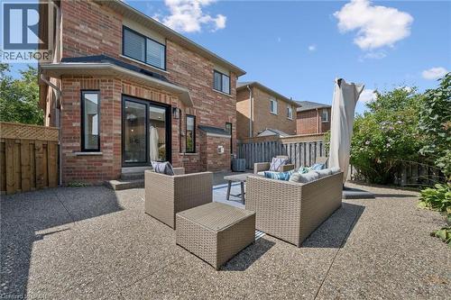 Brick exterior with black-framed windows and a sliding glass door - 2294 Seton Crescent, Burlington, ON 