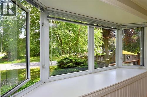 Bay window with multiple operable panels, integrated blinds, a deep window sill, and white beadboard paneling - 936 Boothman Avenue, Burlington, ON 