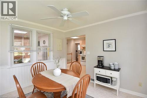 Ceiling fan, crown molding, double windows, wainscoting, and light wall paint - 936 Boothman Avenue, Burlington, ON 