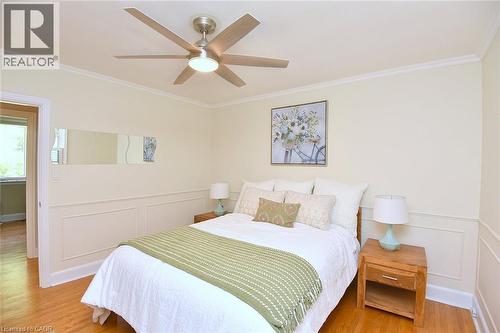 Hardwood flooring, crown molding, ceiling fan with integrated lighting, and wainscoting - 936 Boothman Avenue, Burlington, ON 
