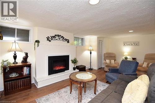 Recessed lighting, wood-finish flooring, white walls, and a fireplace with a mantel - 936 Boothman Avenue, Burlington, ON 