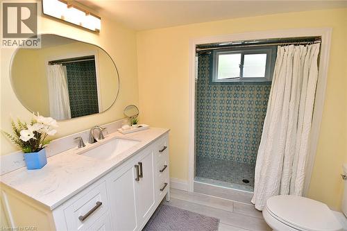 White vanity with integrated sink and chrome fixtures - 936 Boothman Avenue, Burlington, ON 