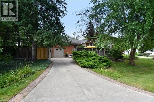 Concrete driveway with brick edging, leading to an attached garage - 936 Boothman Avenue, Burlington, ON 