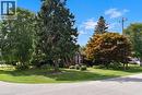 Manicured lawn with mature trees and established landscaping - 936 Boothman Avenue, Burlington, ON 