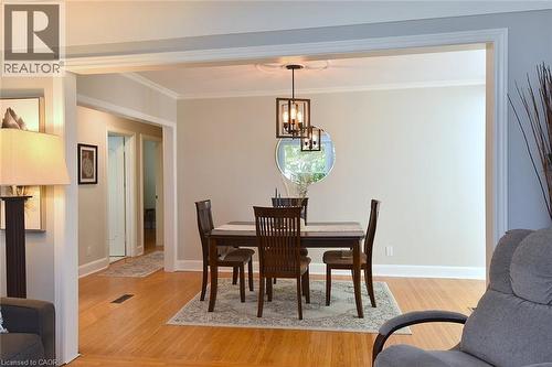 Hardwood flooring throughout, crown molding, and a modern rectangular chandelier - 936 Boothman Avenue, Burlington, ON 