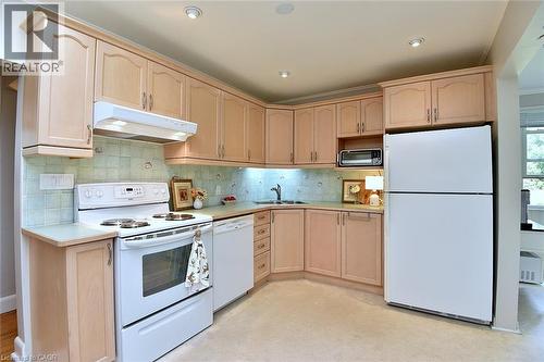 Kitchen featuring light wood cabinetry, recessed lighting, and a tile backsplash - 936 Boothman Avenue, Burlington, ON 