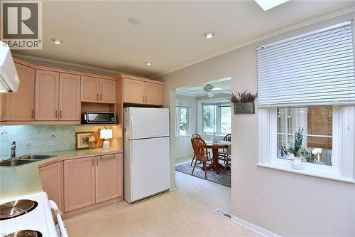 Kitchen featuring wood cabinetry, a double basin sink, tile backsplash, and recessed lighting - 936 Boothman Avenue, Burlington, ON 