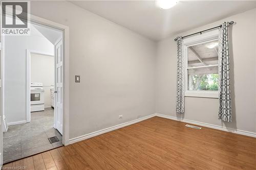 Wood-finish flooring and a white trim baseboard - 160 Lorne Crescent, Kitchener, ON 