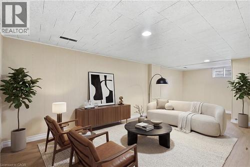 Wood-finish flooring, recessed lighting, drop ceiling, and light-toned wall paneling - 160 Lorne Crescent, Kitchener, ON 