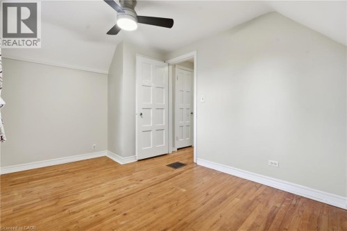 Hardwood flooring, painted walls, ceiling fan, white trim, and paneled interior doors - 160 Lorne Crescent, Kitchener, ON 