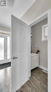Entryway featuring tile flooring and a white paneled door - 
