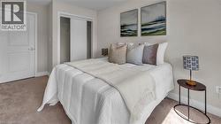 Neutral wall color, carpet flooring, permanent built-in closet with sliding doors, and white paneled door - 
