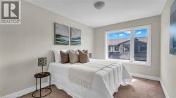 Neutral wall paint, white window trim, brown carpet, and a flush mount ceiling light - 