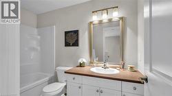 White vanity with brushed nickel hardware, integrated sink, and an expansive countertop - 