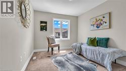 Carpeted flooring, white trim, and a window with white casing - 
