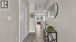 Wood-finish flooring throughout, with flush-mount ceiling lighting, white interior doors, and neutral wall tones - 