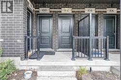 Brick exterior with multiple panel doors and individual unit numbering - 