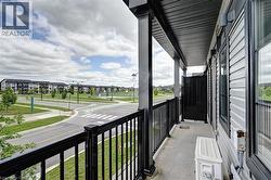 Balcony featuring black metal railings and overhead soffit - 
