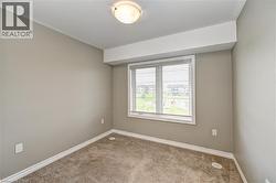 Neutral-toned walls, carpeted flooring, window with horizontal blinds, flush mount ceiling light fixture, white trim - 