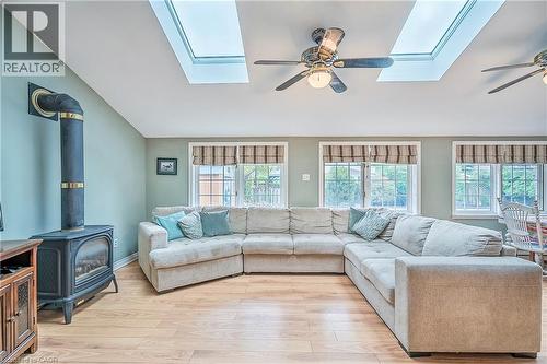 Vaulted ceiling, skylights and ceiling fans help to create a bright space in this living room that looks onto the back yard. - 115 Southwood Drive, Cambridge, ON 
