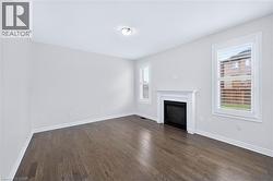 Room featuring a built-in fireplace with a classic white mantel - 