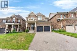Brick exterior with stone accents, covered front entry, and a double-door garage - 