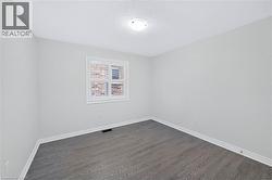 Room with neutral walls and grey wood-finish flooring - 