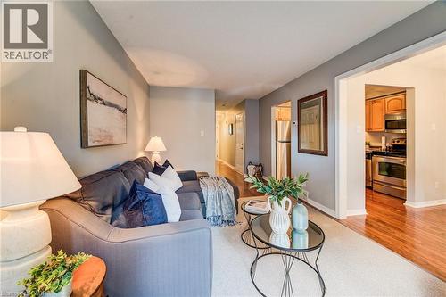 Living area with carpeting and light gray walls - 360 Cornridge Place Unit# 2, Waterloo, ON 