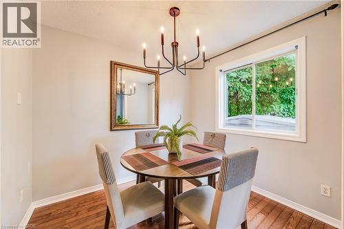 Hardwood flooring throughout, with neutral wall paint, and a classic chandelier - 360 Cornridge Place Unit# 2, Waterloo, ON 
