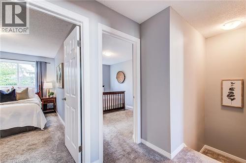 Carpeted flooring throughout, neutral painted walls, and white trim accents - 360 Cornridge Place Unit# 2, Waterloo, ON 