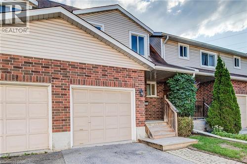 Brick and siding exterior with two garage doors - 360 Cornridge Place Unit# 2, Waterloo, ON 