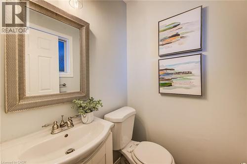 Vanity with integrated basin, brushed nickel faucet, and a decorative framed mirror - 360 Cornridge Place Unit# 2, Waterloo, ON 
