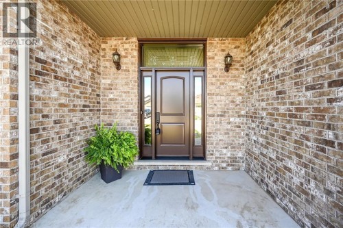 Brick exterior with recessed entry, panel door, and transom window - 10 Balvenie Boulevard, Caledonia, ON 