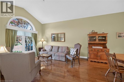 Vaulted ceiling with an arched window, wood-finish flooring, and light-toned walls - 10 Balvenie Boulevard, Caledonia, ON 