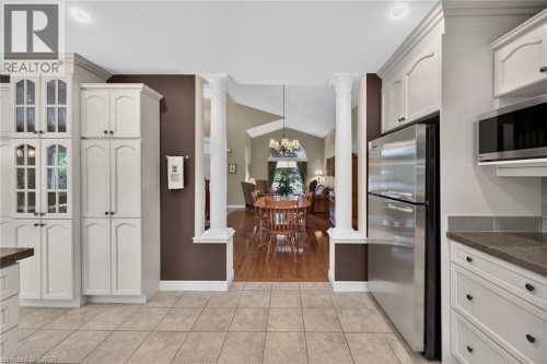 Kitchen featuring tiled flooring, white cabinetry, stainless steel refrigerator, and recessed lighting - 10 Balvenie Boulevard, Caledonia, ON 