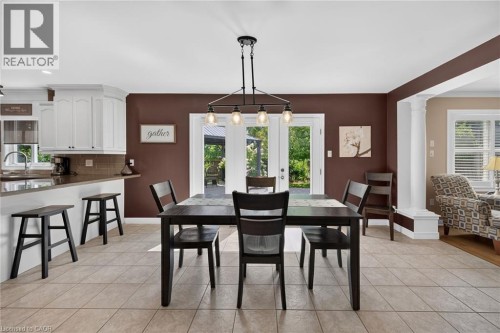 White cabinetry with a tiled backsplash - 10 Balvenie Boulevard, Caledonia, ON 
