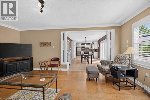 Hardwood flooring, crown molding, track lighting, interior columns, and a kitchen with stainless steel appliances - 10 Balvenie Boulevard, Caledonia, ON 