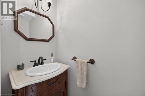 Curved wood vanity with an integrated sink and an oil-rubbed bronze faucet - 10 Balvenie Boulevard, Caledonia, ON 